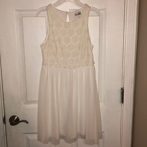 White sleeveless dress with lace detailing on top